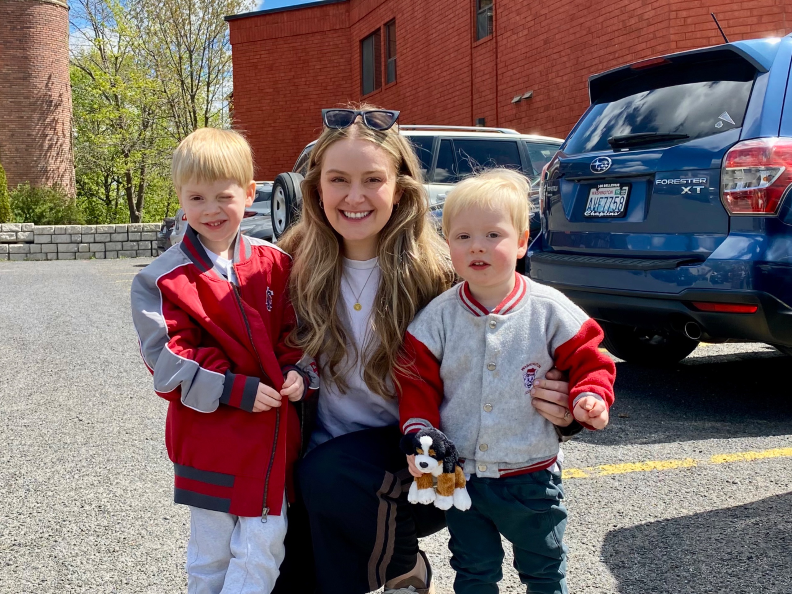Woman posing with two young boys outdoors