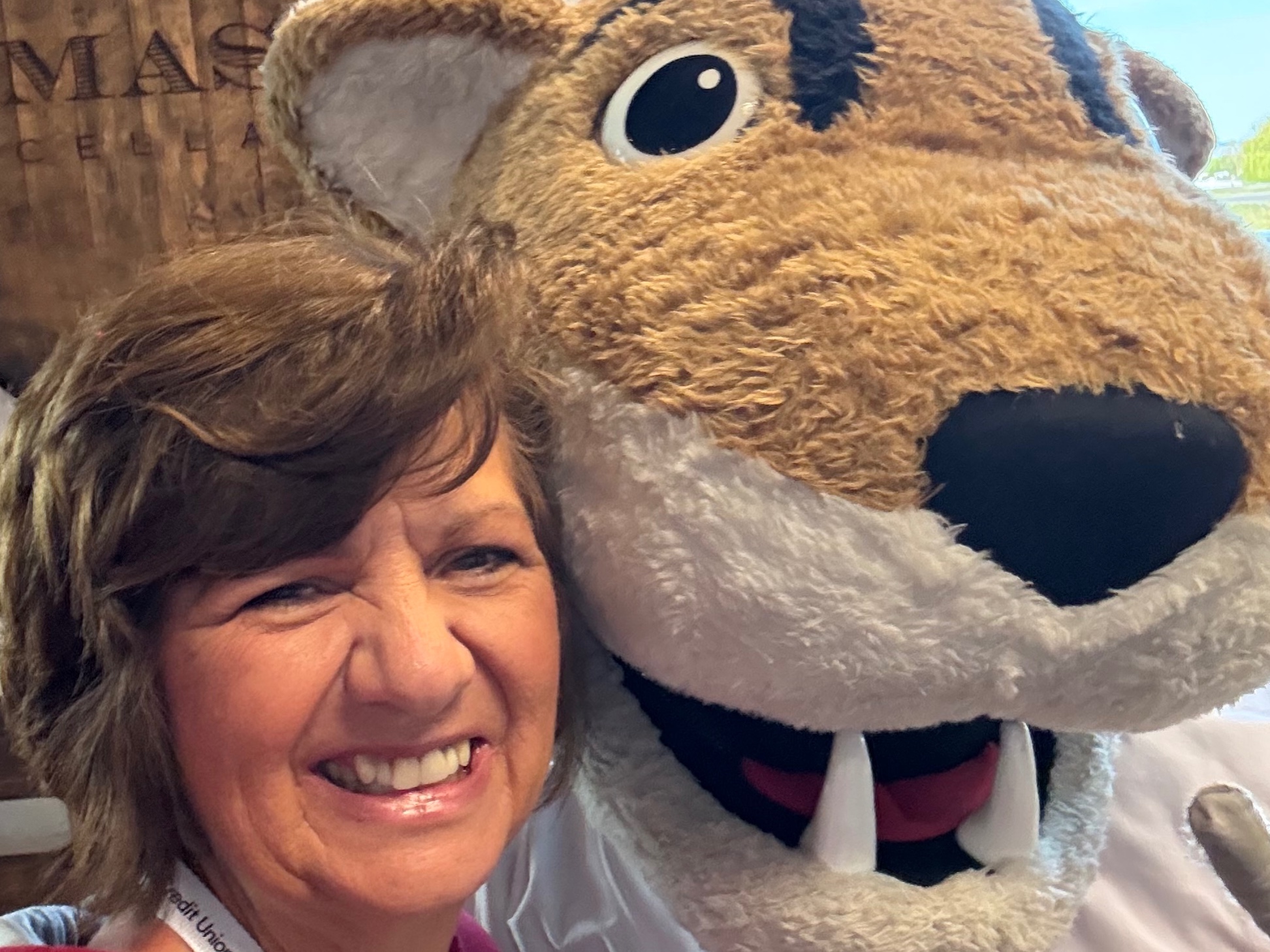 Woman smiling with large beaver mascot